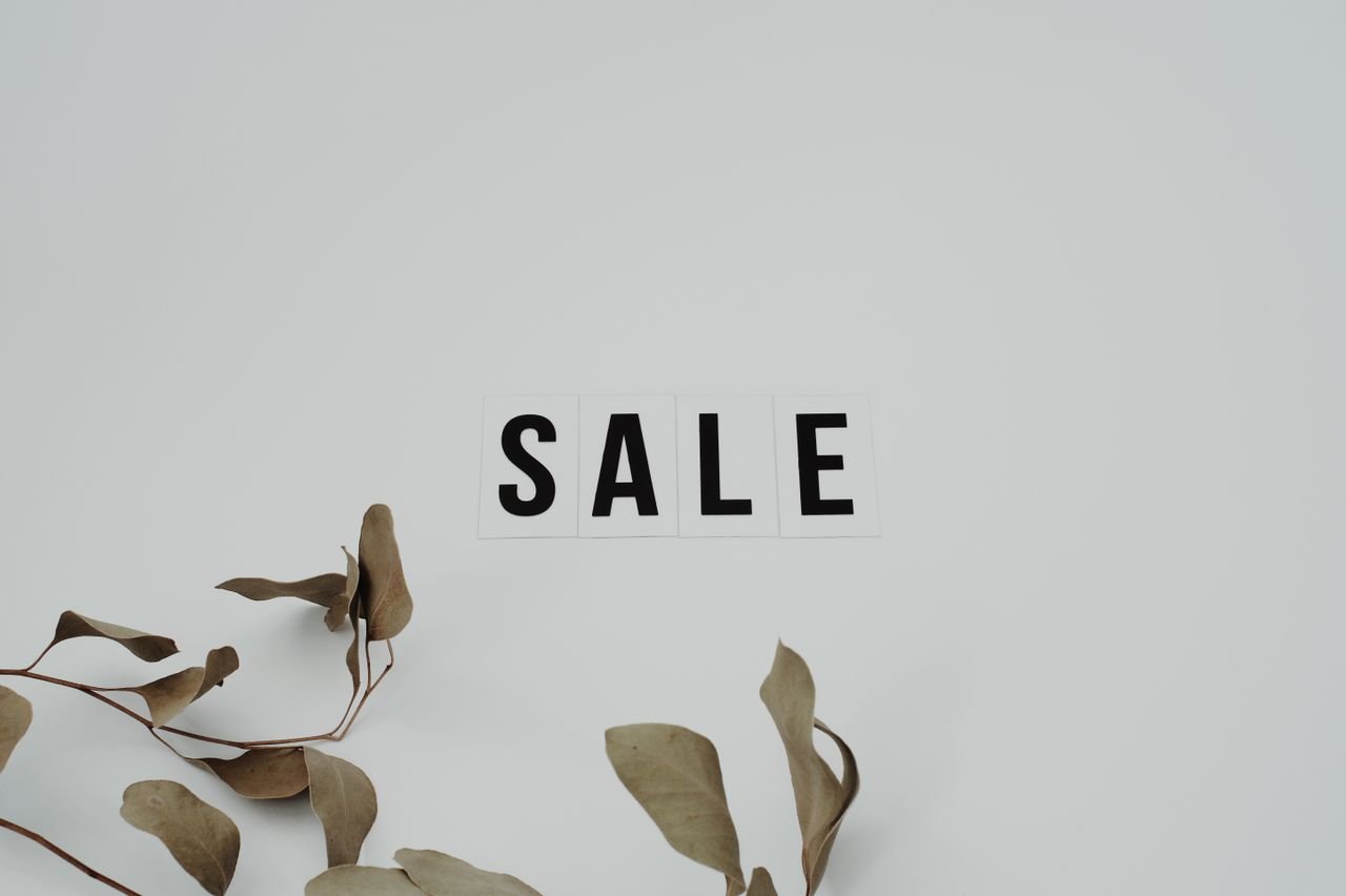 Crafting Captivating Headlines: Your awesome post title goes here Minimalist SALE sign with eucalyptus leaves on white background, perfect for retail marketing.